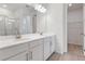 Bright bathroom featuring a double sink vanity with modern fixtures and a walk-in closet at 4224 Sawtooth Ct, Tavares, FL 32778
