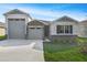 Charming home showcasing a stone facade, well-manicured lawn, and attached three-car garage at 4224 Sawtooth Ct, Tavares, FL 32778