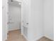 Bright hallway with closet, utilities access and a glimpse of the laundry room at 4224 Sawtooth Ct, Tavares, FL 32778