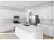 Bright and airy kitchen features white cabinetry, an island, stainless steel appliances at 4224 Sawtooth Ct, Tavares, FL 32778