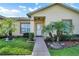 Charming front door view with manicured landscaping and stone walkway at 526 Maricopa Dr, Kissimmee, FL 34758