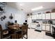 Cozy kitchen with modern appliances, white cabinets, and a dining area with a wooden table at 526 Maricopa Dr, Kissimmee, FL 34758