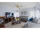 Comfortable living room with a flat-screen TV, sofas, neutral walls, and bright windows at 526 Maricopa Dr, Kissimmee, FL 34758