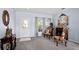 Elegant living room with carpet, decorative furniture, a front door view, and neutral paint at 526 Maricopa Dr, Kissimmee, FL 34758