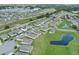 Neighborhood featuring houses, roads, and a pond; wide angle view at 816 William Way, Haines City, FL 33844