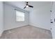Bright bedroom features neutral carpet, a ceiling fan, and a window with natural light at 2909 Annalee Rd, Saint Cloud, FL 34771