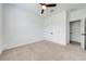 Cozy bedroom with neutral carpet, ceiling fan, and double closet doors at 2909 Annalee Rd, Saint Cloud, FL 34771