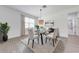 Bright dining room with modern furniture and decor and a view through the window at 2909 Annalee Rd, Saint Cloud, FL 34771