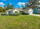 A charming single-story home with a well-maintained lawn and cozy curb appeal under a partly cloudy sky at 2909 Annalee Rd, Saint Cloud, FL 34771