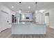 Kitchen island featuring stainless steel sink, granite countertops, modern pendant lights, and ample cabinet space at 2909 Annalee Rd, Saint Cloud, FL 34771