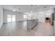 Open kitchen with stainless steel appliances, granite countertops, island sink, and adjacent laundry room at 2909 Annalee Rd, Saint Cloud, FL 34771