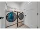 Laundry room with front load washer and dryer and a white door at 2909 Annalee Rd, Saint Cloud, FL 34771