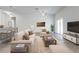 Cozy living room featuring a sofa, easy chair, and tile flooring, staged with modern decor at 2909 Annalee Rd, Saint Cloud, FL 34771