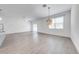 Sunlit living space featuring light flooring, a modern ceiling fan, and sliding glass doors to the backyard at 2909 Annalee Rd, Saint Cloud, FL 34771