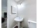 Simple bathroom with pedestal sink and white toilet at 32122 Hickory Ln, Sorrento, FL 32776