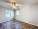 Spacious bedroom with ceiling fan and large window at 32122 Hickory Ln, Sorrento, FL 32776