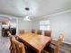 Spacious dining room with wooden table and view into the kitchen at 32122 Hickory Ln, Sorrento, FL 32776