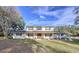 Two-story house with white siding, brown double doors, and a landscaped lawn at 32122 Hickory Ln, Sorrento, FL 32776