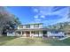 Two-story home with white brick exterior and large yard at 32122 Hickory Ln, Sorrento, FL 32776