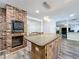 Kitchen with island, stainless steel appliances, and brick fireplace at 32122 Hickory Ln, Sorrento, FL 32776