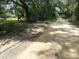 Peaceful country road lined with trees at 32122 Hickory Ln, Sorrento, FL 32776