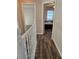 Upstairs hallway with wood flooring and white railing at 32122 Hickory Ln, Sorrento, FL 32776