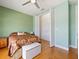 Bedroom with light green walls, hardwood floors and large closet at 352 Radisson Pl, Oviedo, FL 32765