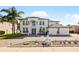 Two-story house with white exterior, paver driveway and fountain at 352 Radisson Pl, Oviedo, FL 32765