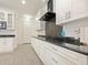 Modern white kitchen with black granite countertops and stainless steel appliances at 352 Radisson Pl, Oviedo, FL 32765