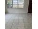 Living room with tile floors and large windows at 4910 Huppel Ave, Orlando, FL 32811