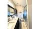Nicely remodeled bathroom with double sinks, a marble countertop, a tiled shower, and modern fixtures at 144 Rose Hill Trl, Sanford, FL 32773