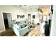 Bright living room with vaulted ceilings, modern furnishings, and wood-look floors at 144 Rose Hill Trl, Sanford, FL 32773