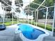 Inviting screened-in pool featuring a sun shelf and ample space for lounging, perfect for outdoor enjoyment at 144 Rose Hill Trl, Sanford, FL 32773