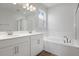 This spacious bathroom boasts double sinks, tile floors, and a relaxing soaking tub at 192 Flag Lilly Ln, Umatilla, FL 32784