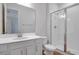 This bathroom includes a walk-in shower, toilet, sink with vanity and tiled flooring at 192 Flag Lilly Ln, Umatilla, FL 32784
