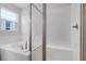 The stylish bathroom features a frameless glass shower and soaking tub at 192 Flag Lilly Ln, Umatilla, FL 32784