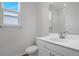 Bright bathroom featuring sleek vanity, mirror and shower with neutral walls at 192 Flag Lilly Ln, Umatilla, FL 32784