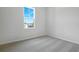Bright bedroom featuring plush carpet, a window, and neutral walls at 192 Flag Lilly Ln, Umatilla, FL 32784