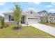 Charming single-story home boasts a manicured lawn and neutral colors at 192 Flag Lilly Ln, Umatilla, FL 32784