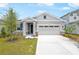 Charming single-story home boasts a manicured lawn and neutral colors at 192 Flag Lilly Ln, Umatilla, FL 32784