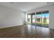 Bright living room with sleek wood-look tile floors and sliding door at 192 Flag Lilly Ln, Umatilla, FL 32784