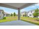 Covered back patio overlooking the sprawling backyard, great for outdoor relaxation and entertainment with neighborhood views at 196 Flag Lilly Ln, Umatilla, FL 32784