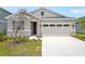 Charming single-Gathering home with a two-car garage, stone accents, neutral paint colors, and a well-maintained lawn at 196 Flag Lilly Ln, Umatilla, FL 32784