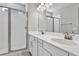 Bright bathroom with dual sinks, white cabinets, and a glass-enclosed shower at 203 Bull Frog Ln, Umatilla, FL 32784