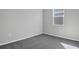 Comfortable bedroom with plush carpet, a window view, and neutral-colored walls at 203 Bull Frog Ln, Umatilla, FL 32784