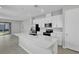 Modern kitchen with stainless steel appliances, white cabinets, and a large center island at 203 Bull Frog Ln, Umatilla, FL 32784