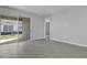 Well-lit living room featuring tile flooring, sliding glass doors, and neutral paint at 203 Bull Frog Ln, Umatilla, FL 32784