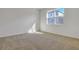 Comfortable bedroom with neutral carpet, large window, and plenty of natural light at 207 Bull Frog Ln, Umatilla, FL 32784