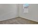 Cozy bedroom with plush carpeting, a bright window letting in natural light, and neutral tones at 207 Bull Frog Ln, Umatilla, FL 32784