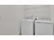Functional laundry room with a washer, dryer, and wire shelving for organized storage solutions at 207 Bull Frog Ln, Umatilla, FL 32784